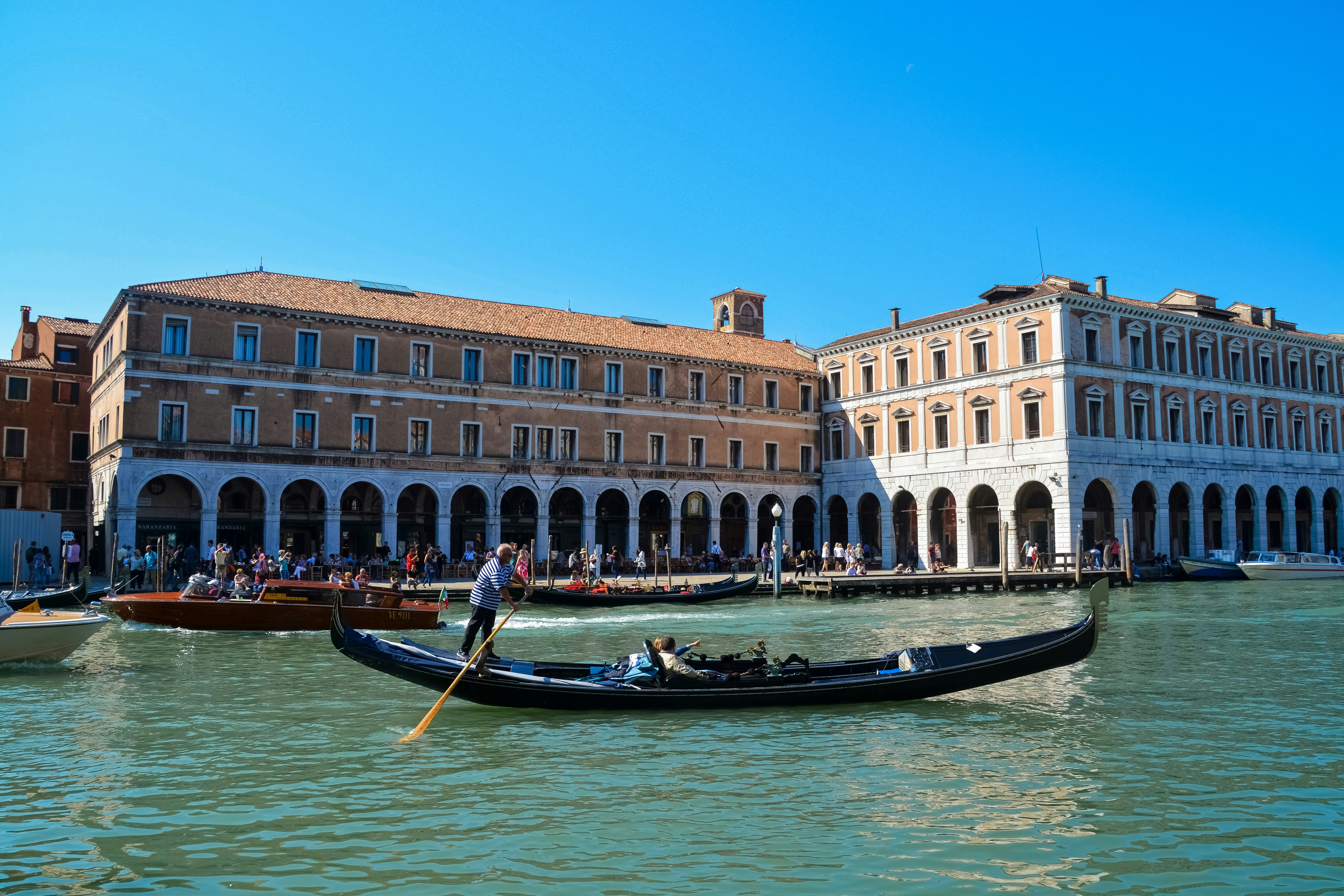 people riding on boat on river near building during daytime